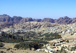 Tourist walking through the rocky terrain of Petra